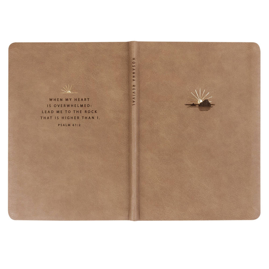The taupe notebook opened flat, showing back and front covers