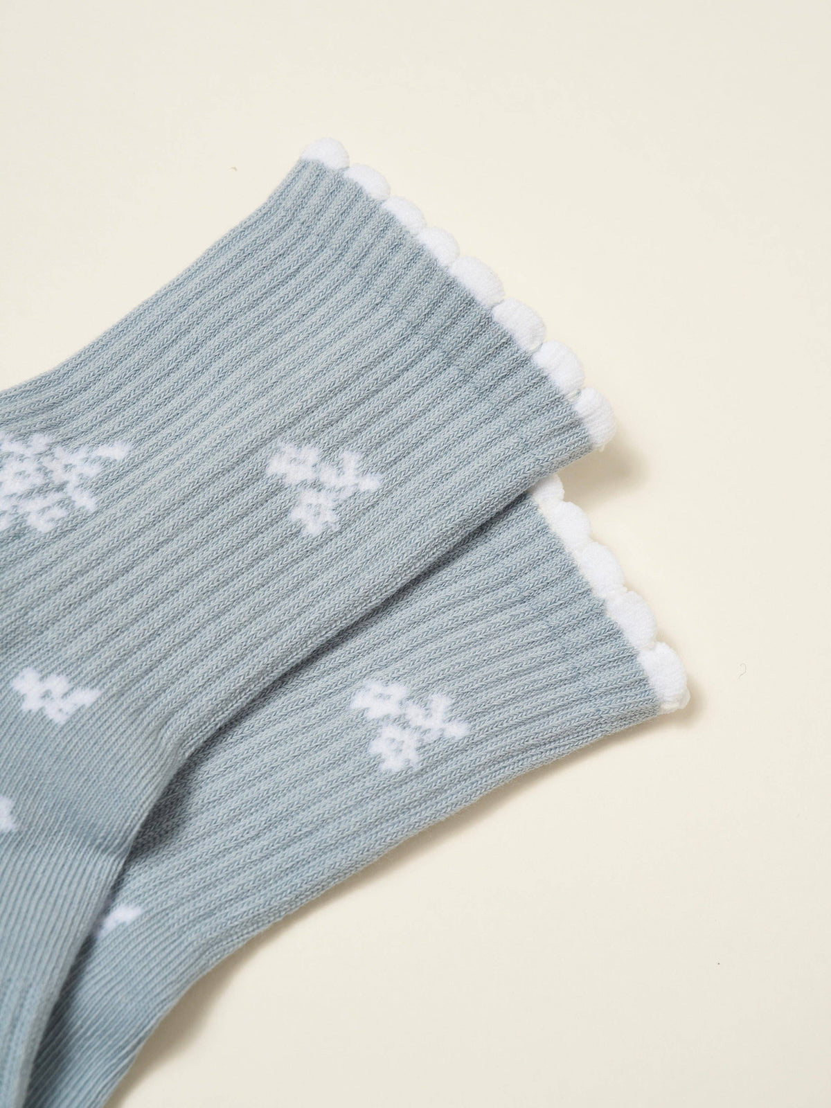 Close view of the white snowflakes on the ribbed blue cuff