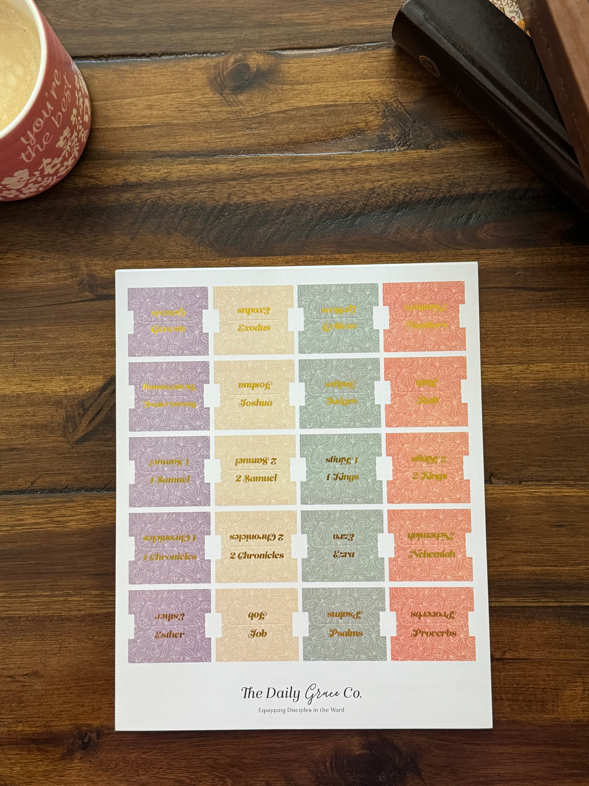 Sheet of speckled Bible tabs in lilac, butter, sage and coral with gold book names