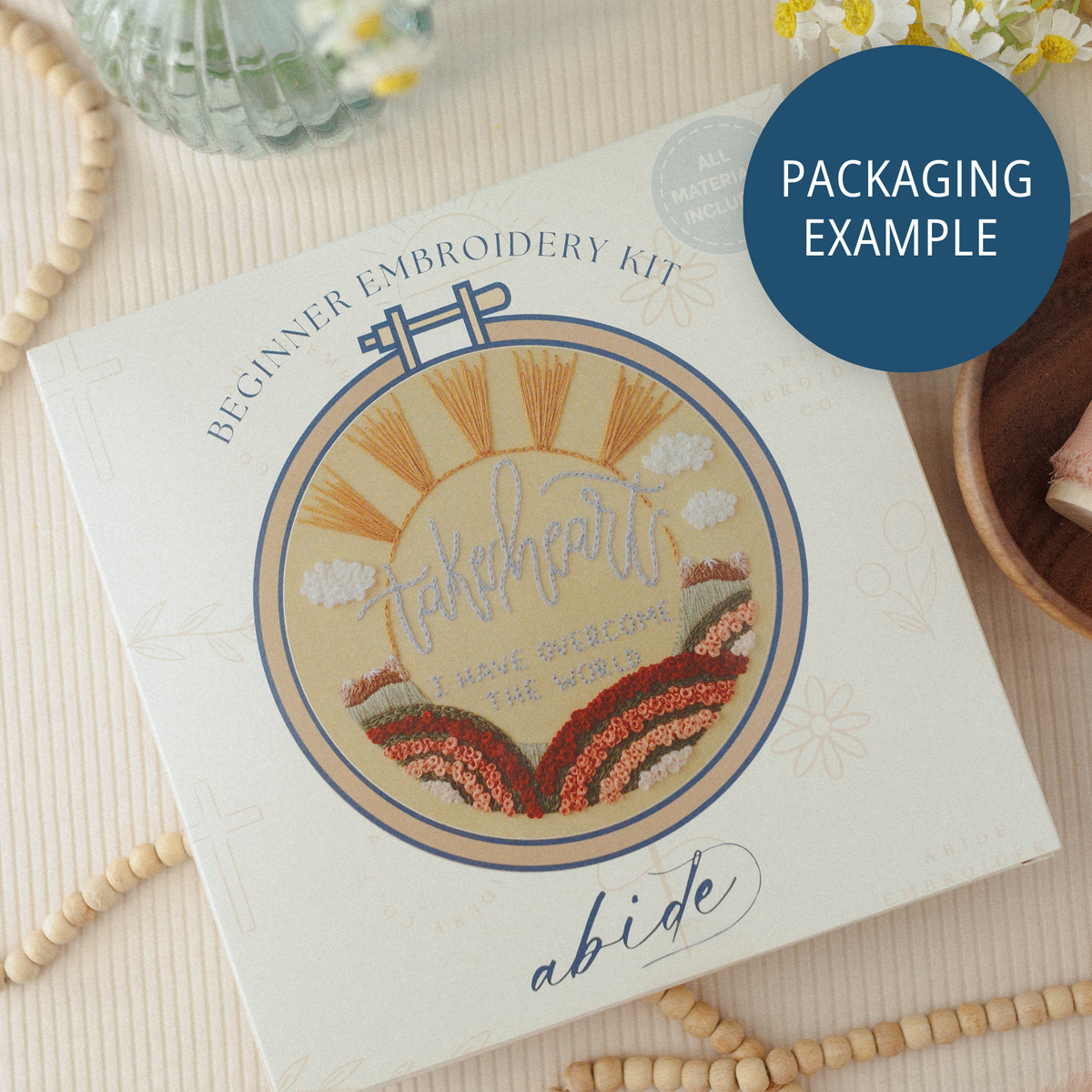 Packaging example: a beginner embroidery kit box with a sunrise hoop design
