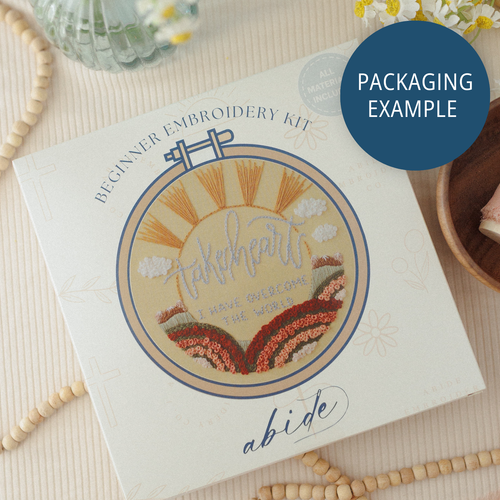 Packaging example: a beginner embroidery kit box with a sunrise hoop design