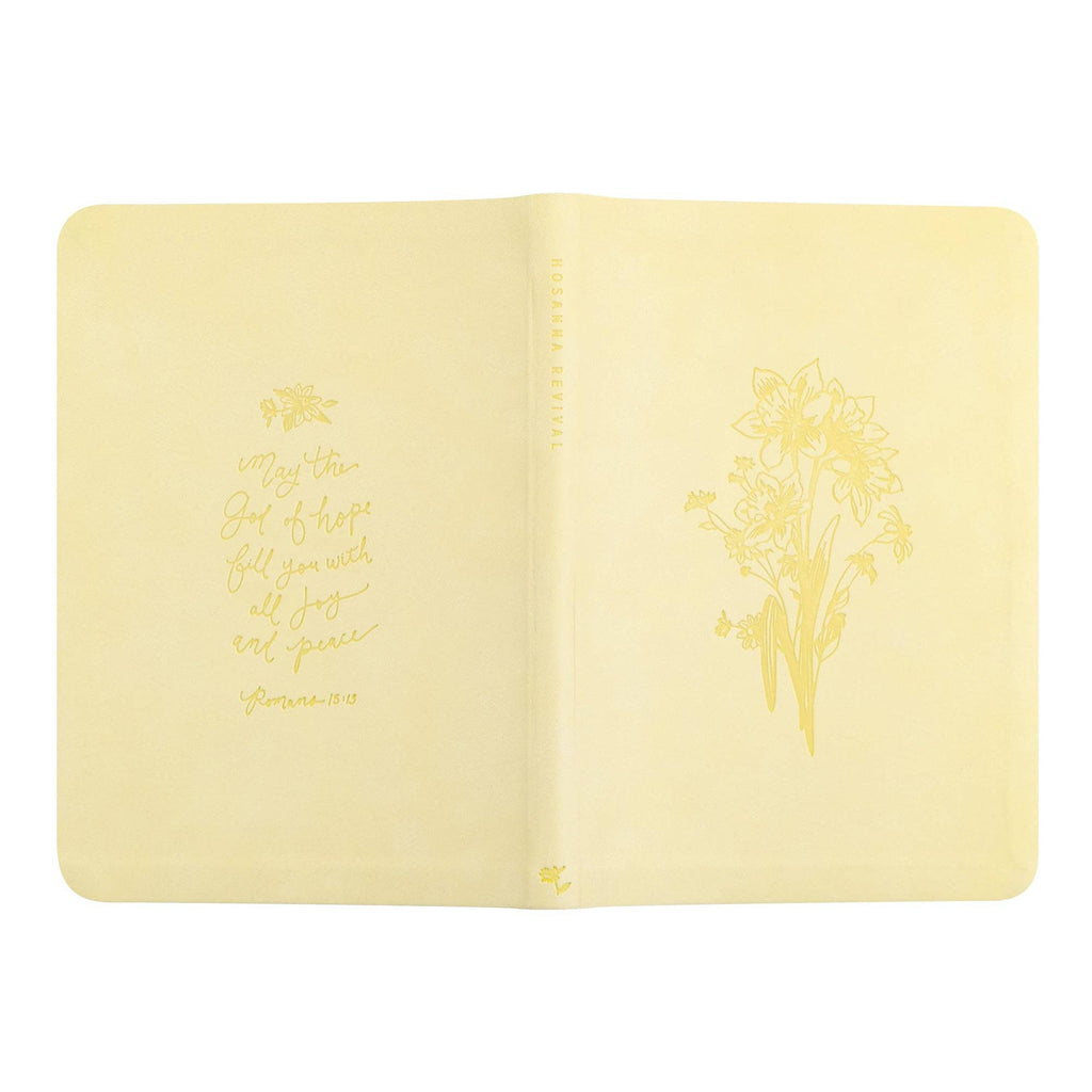The yellow notebook opened flat, showing back and front covers