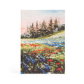 Hardcover notebook with a painted wildflower meadow of red, blue and white flowers below pine trees