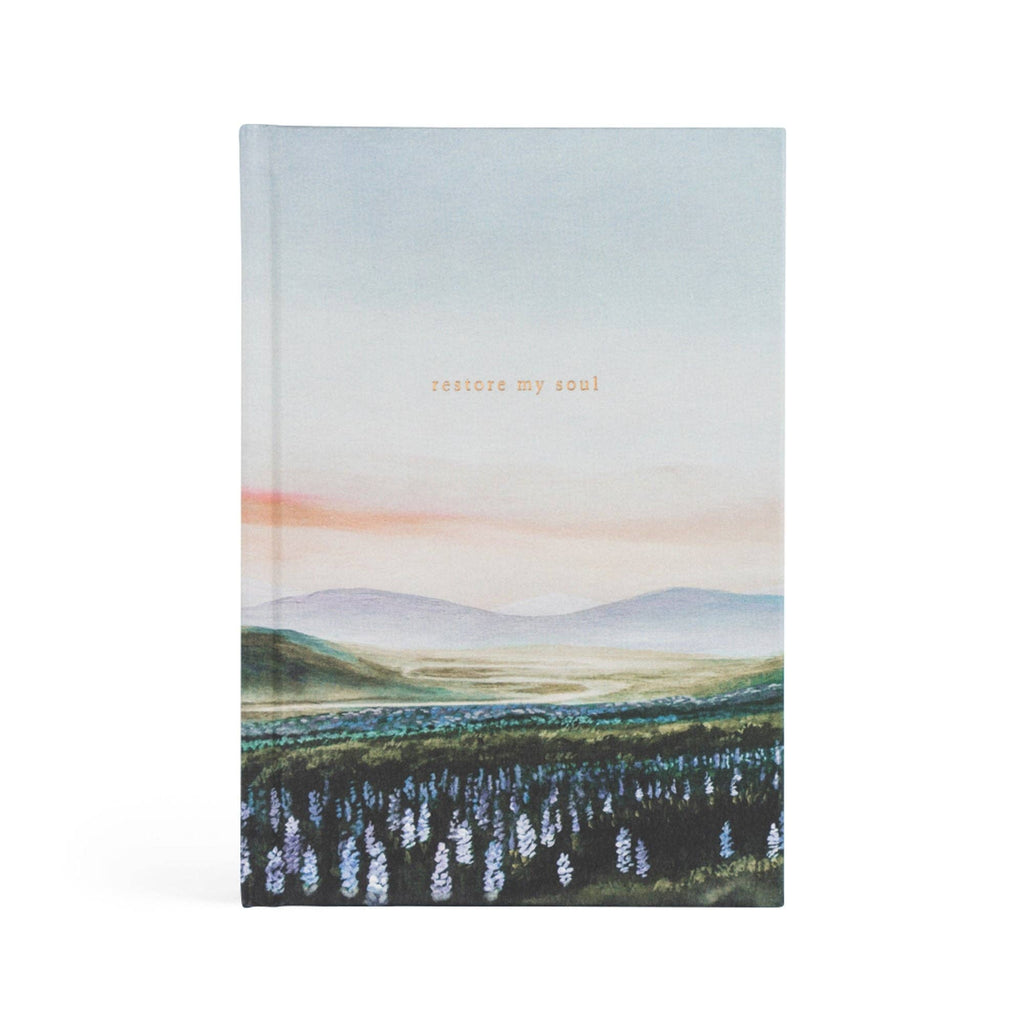 Hardcover notebook painted with purple lupines, green hills and a pink-streaked sky, titled "restore my soul"