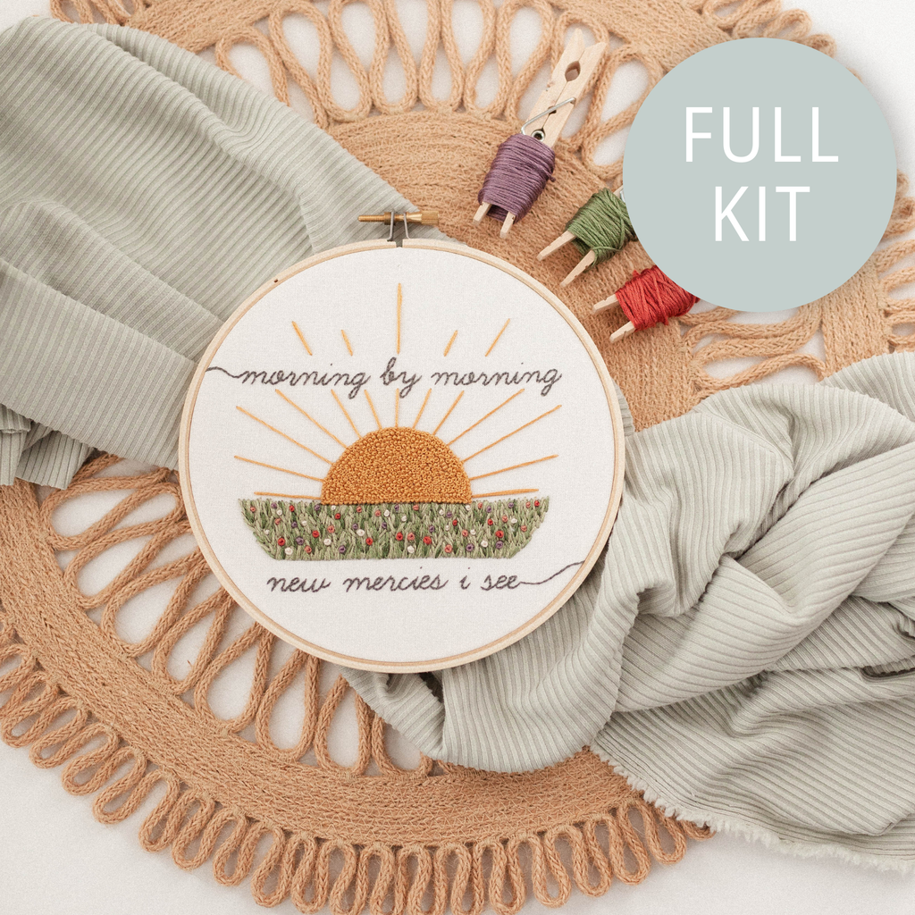Finished hoop: "morning by morning new mercies I see" around a stitched sunrise over a field