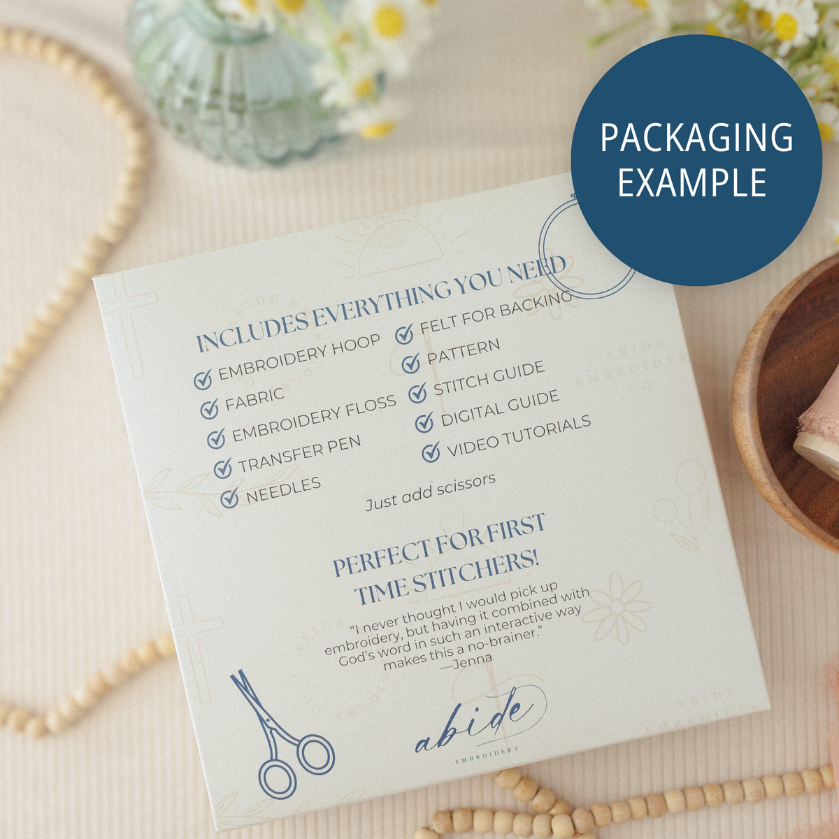 Packaging example: back of the box listing hoop, fabric, floss, needles, pattern and guides