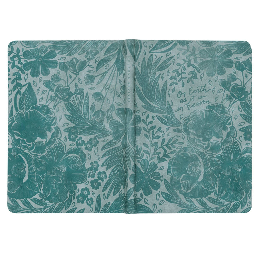 The teal notebook opened flat, showing the wraparound floral emboss