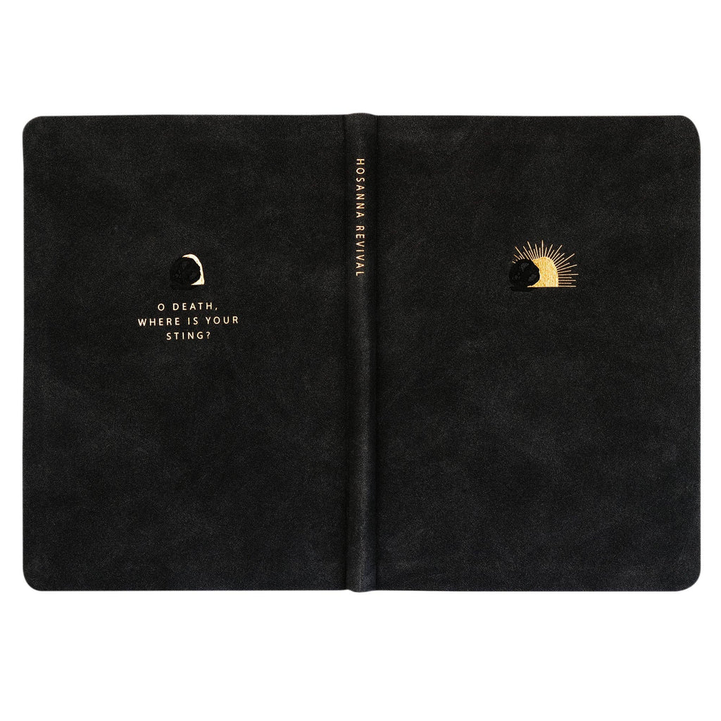 The black notebook opened flat, showing back and front covers