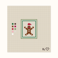 Gingerbread Man hand-painted needlepoint canvas: a gingerbread man in a Santa hat
