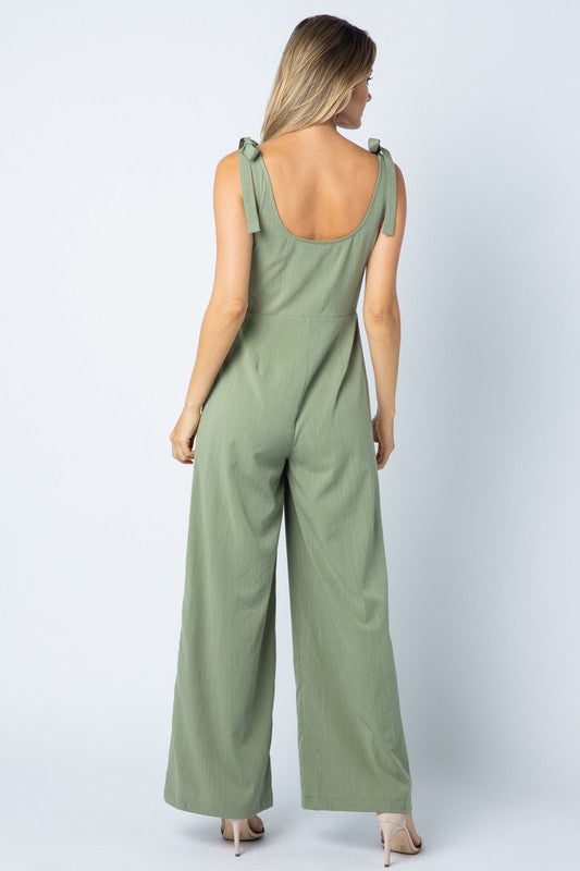 Back view of the sage jumpsuit with its scoop back and tie straps