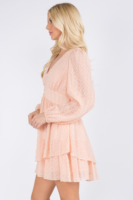 Side view of the peach swiss-dot dress showing the tiered ruffle skirt