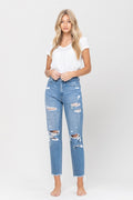 Light-wash high-rise distressed jeans with ripped knees and frayed hems, worn with a white tee