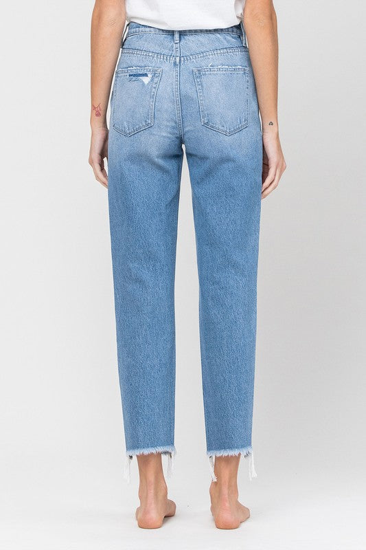 Back view of the light-wash jeans showing the pockets and frayed hems