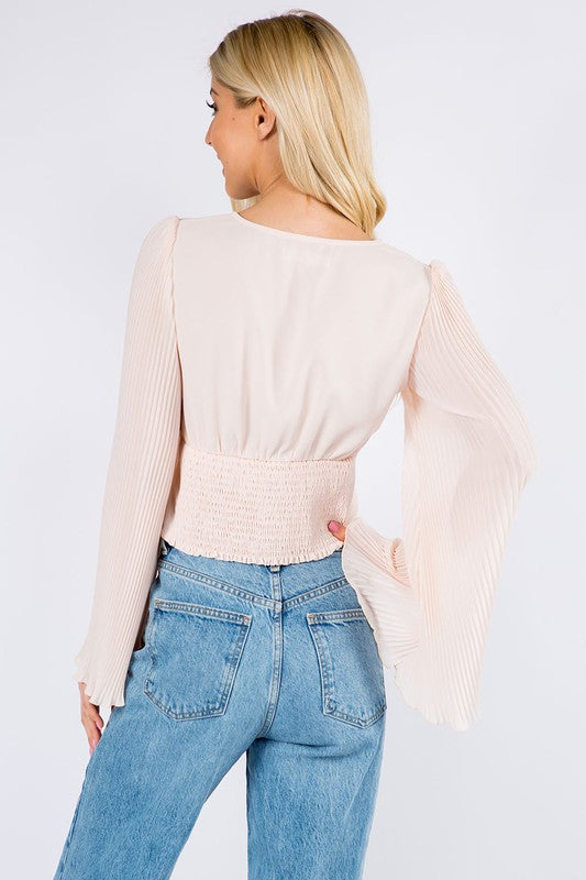 Back view of the blush top showing the smocked waist