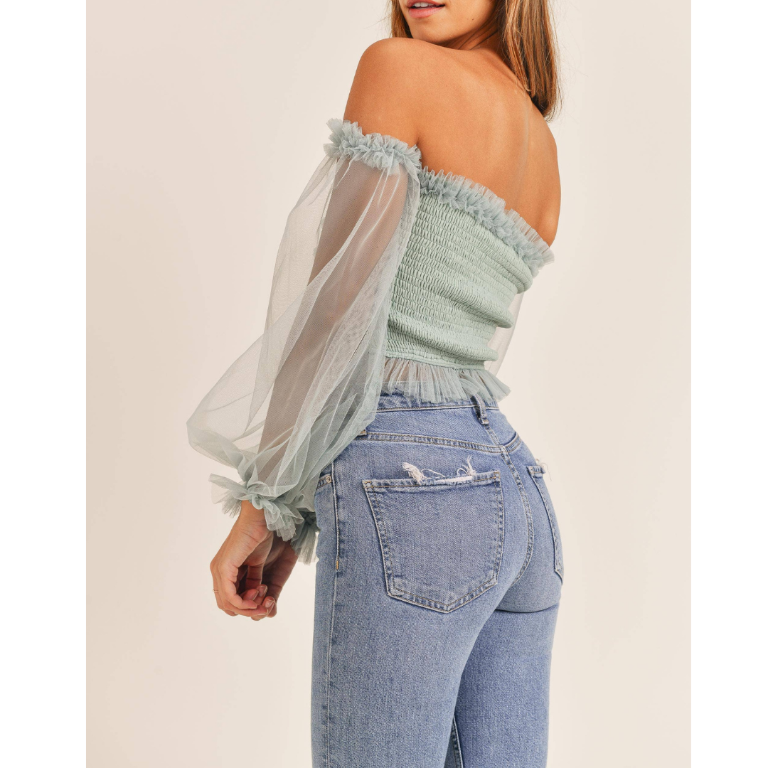 Back view of the sage smocked top and sheer sleeves