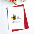 Greeting card with a cartoon bumblebee and "Bee mine?" on a red envelope