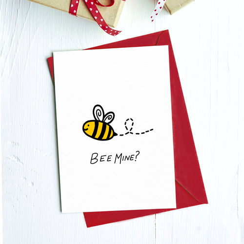 Greeting card with a cartoon bumblebee and "Bee mine?" on a red envelope
