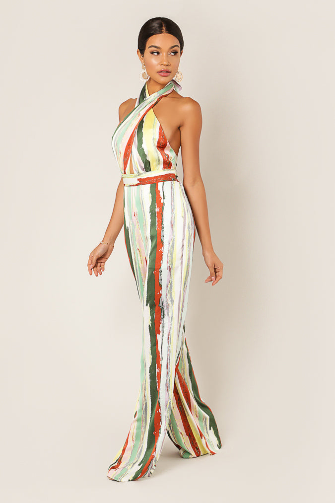 Side view of the striped halter jumpsuit's crossover neckline and wide leg