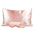 Blush pink satin pillowcase with a matching sleep mask and scrunchie