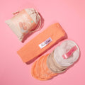 Peach and cream round makeup removing pads with a peach headband and drawstring bag
