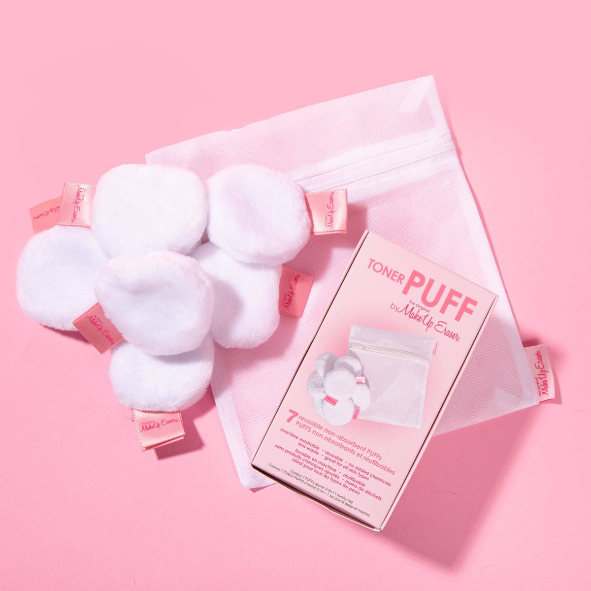 Seven white fluffy toner puffs with a mesh laundry bag and box