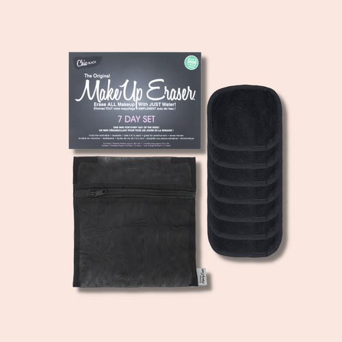 Seven small black makeup removing pads with a mesh laundry bag and the box