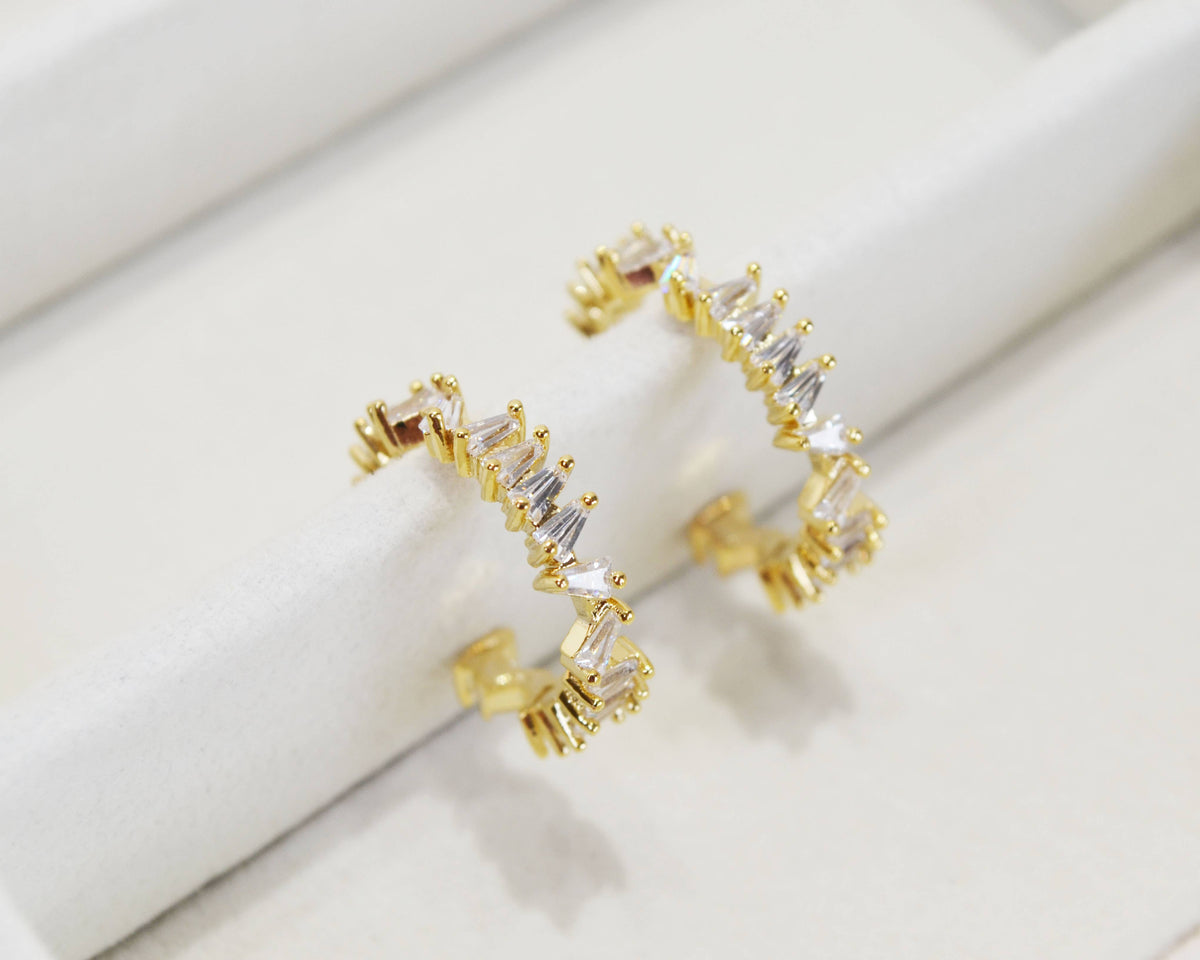 Gold open hoop earrings set with clear baguette crystals