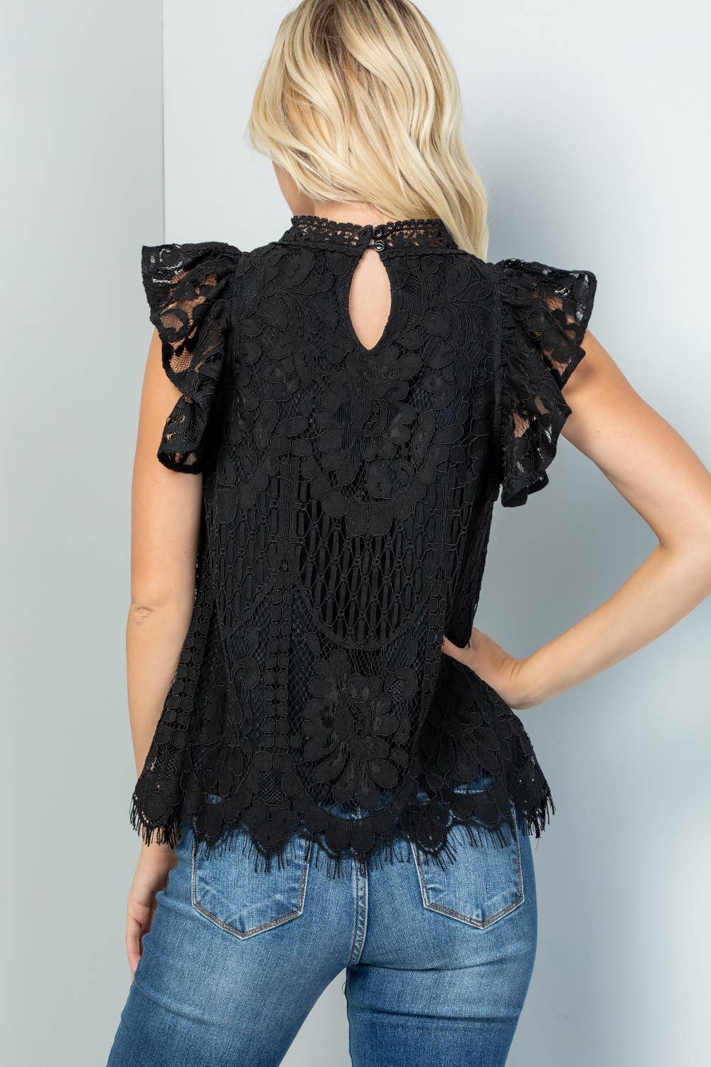 Back view of the black lace top with a keyhole button closure