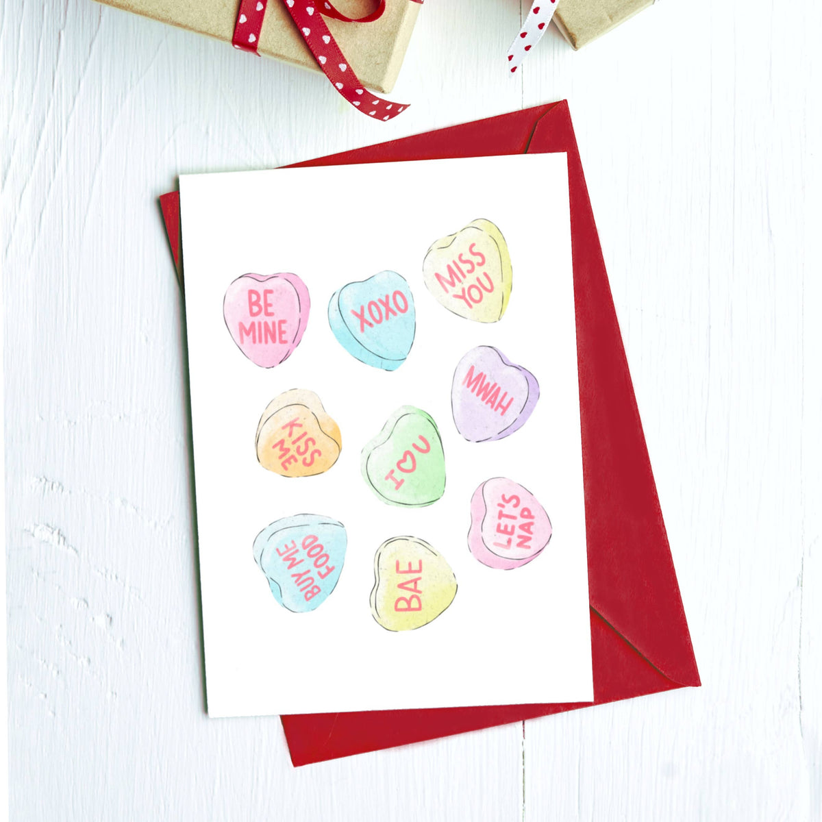 Greeting card of pastel candy conversation hearts: Be mine, XOXO, Miss you and more