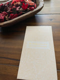 Sticky note set in a cream folder with a white leaf pattern, closed