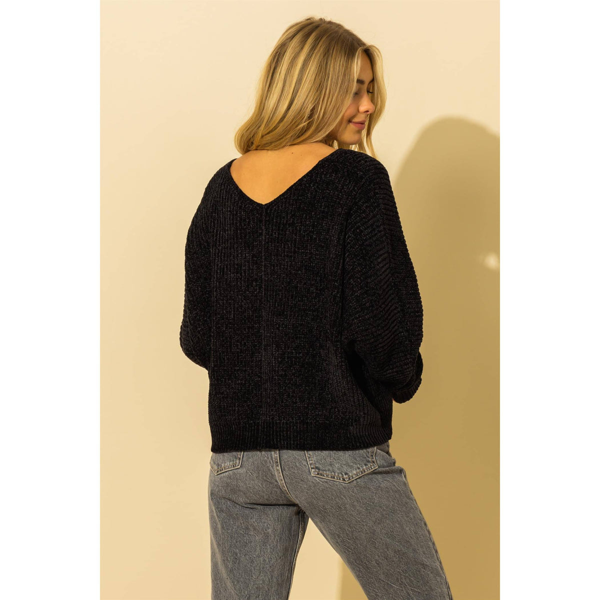 Back view of the black sweater's V-back