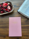 Pink linen-covered sermon notes journal with a gold-foiled title