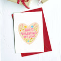 Greeting card with a floral heart reading "Happy Valentine's my love" on a red envelope