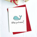 Greeting card with a cartoon blue whale and "Whale you be mine?" on a red envelope